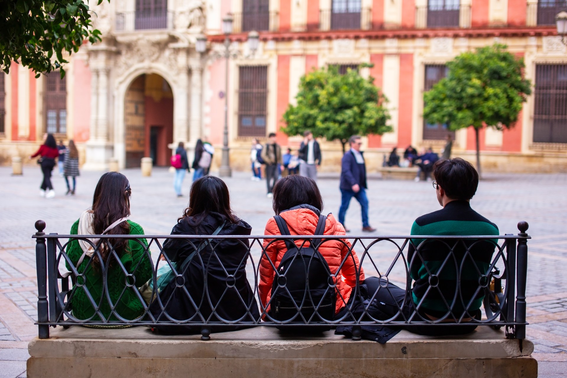 Étudiants se détendant sur un banc, sur une place de Séville